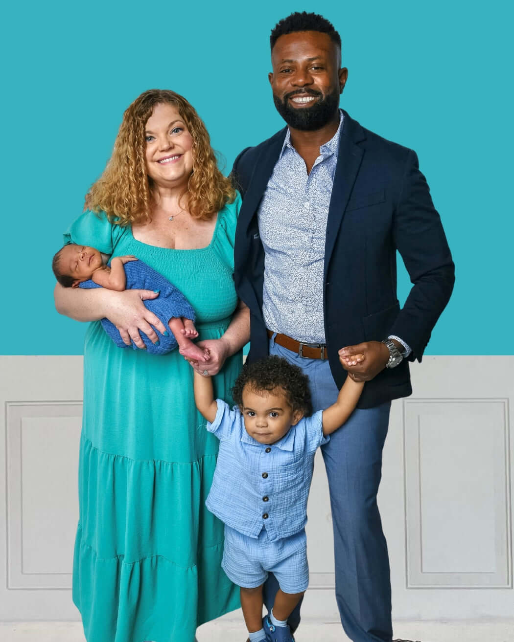 Joseph's Family of four with a baby and toddler against a blue wall