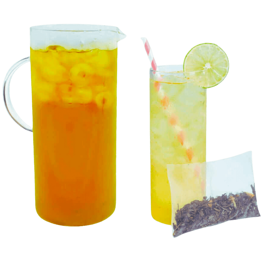 Glass pitcher and glass of iced tea with a lime wedge, next to a tea bag on a white background.
