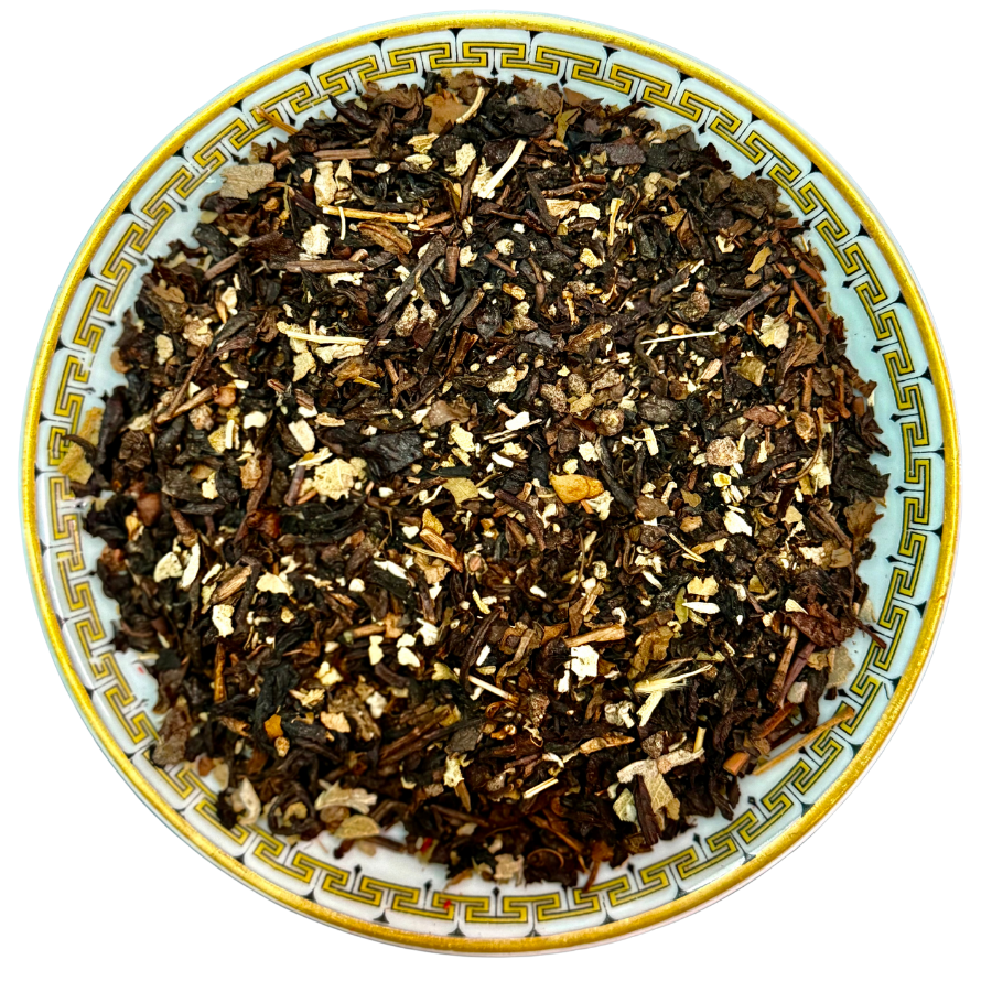 Tea leaves on a decorative ceramic plate with a white background