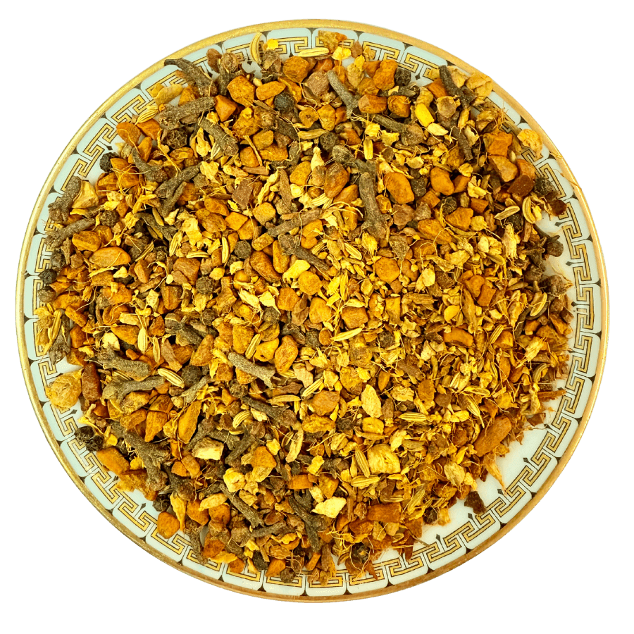 Dried herbs and spices on a decorative plate with a white background