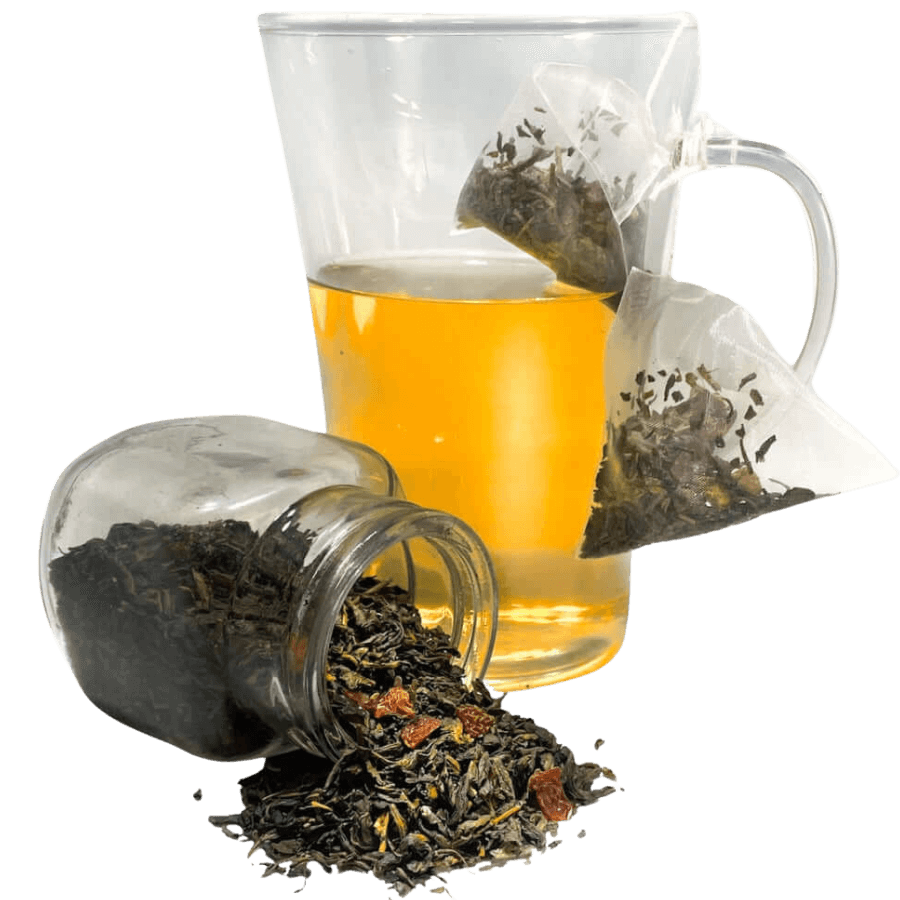Clear glass mug with tea, loose tea leaves, and tea bags on a white background