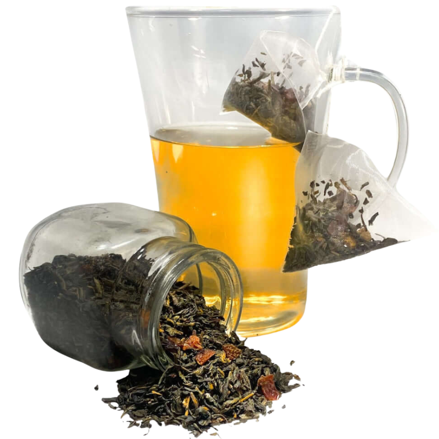 Clear glass mug with tea, loose tea leaves, and tea bags on a white background