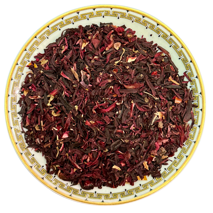 Dried hibiscus tea leaves on a decorative plate with a white background