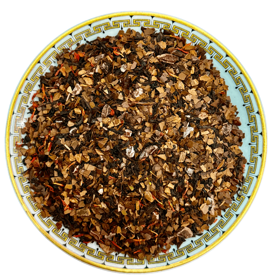 Tea leaves on a decorative ceramic plate with a white background