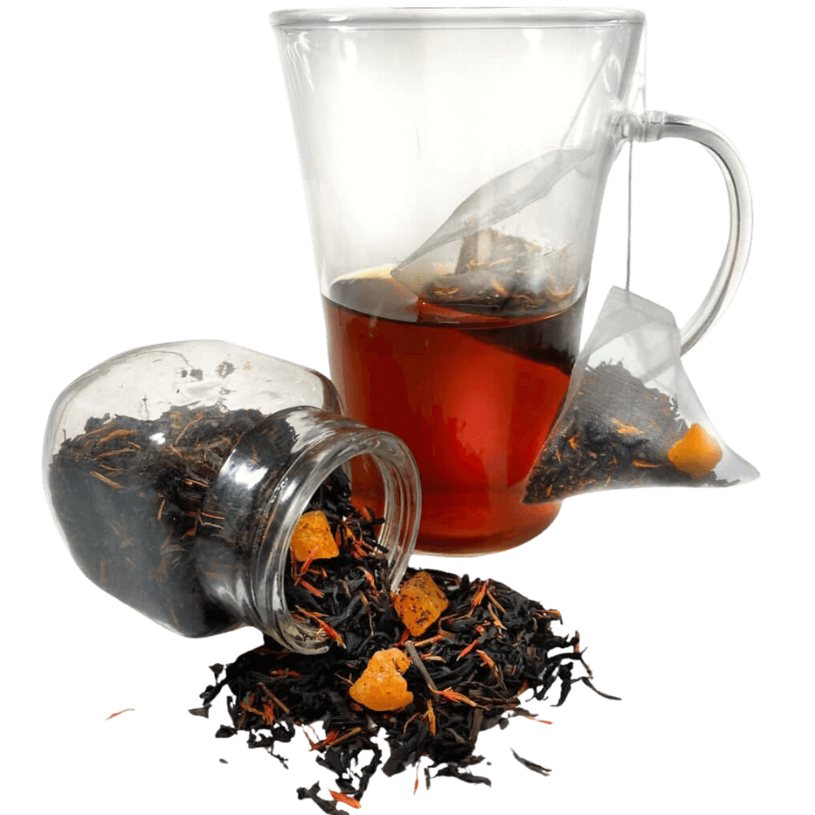 Tea bag, loose tea leaves, and a glass teacup with tea on a white background