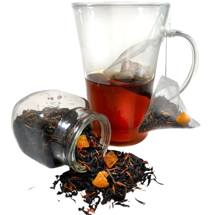 Tea bag, loose tea leaves, and a glass teacup with tea on a white background