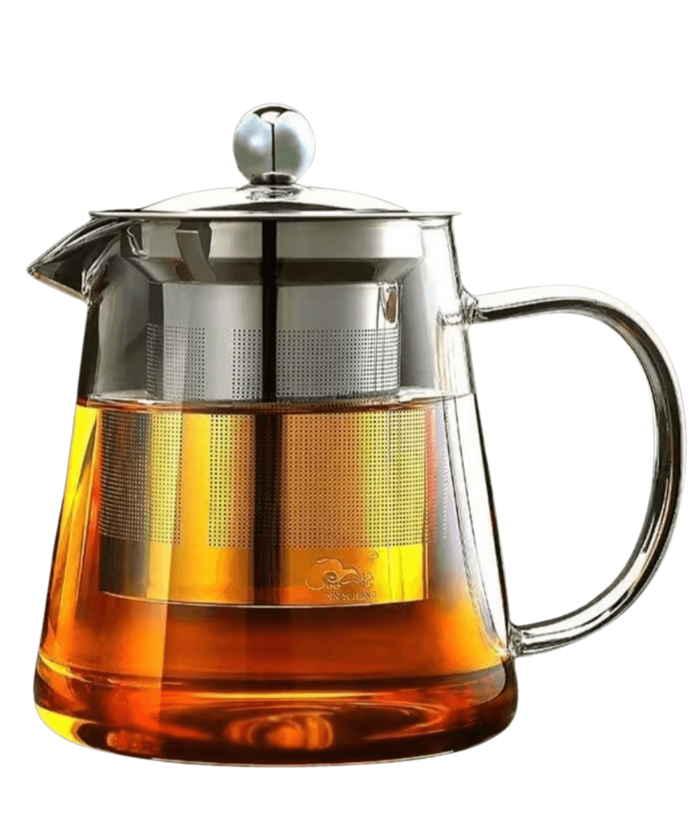 Clear glass teapot with metal infuser filled with tea on a white background