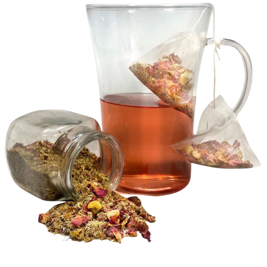 Tea bag in a glass cup with loose tea leaves on a white background