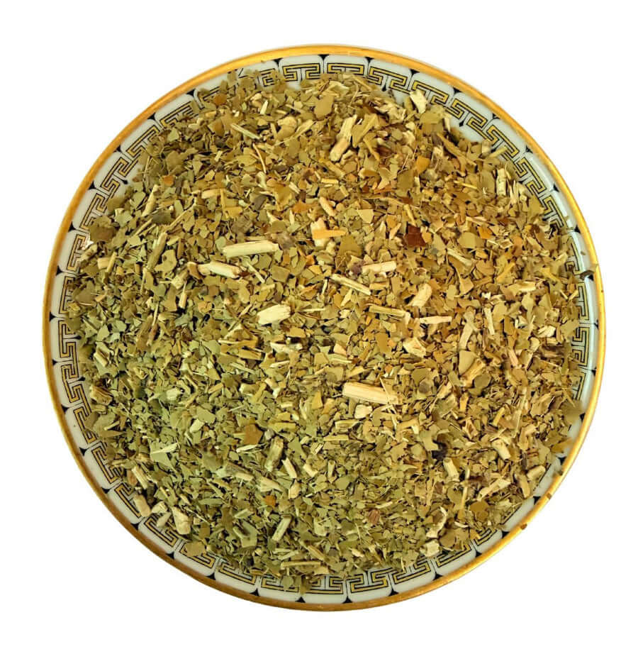 Dried herbs in a decorative bowl on a white background