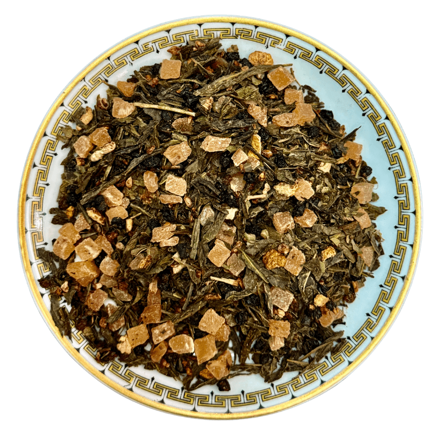 blacberry citrus GreenteaTea leaves on a decorative plate with a white background
