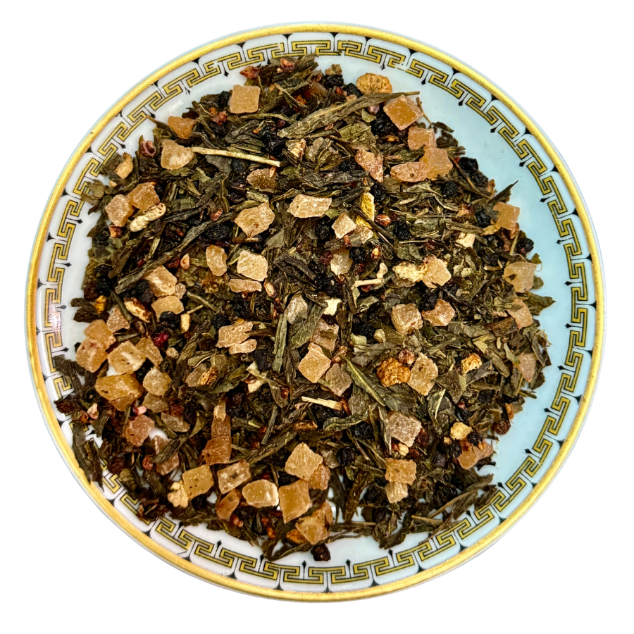 blacberry citrus GreenteaTea leaves on a decorative plate with a white background