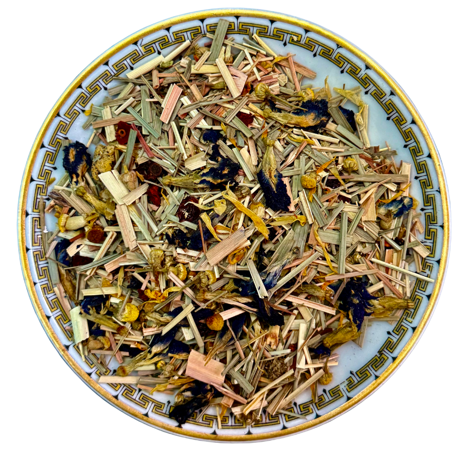 Assorted dried herbs and flowers on a decorative plate with a white background