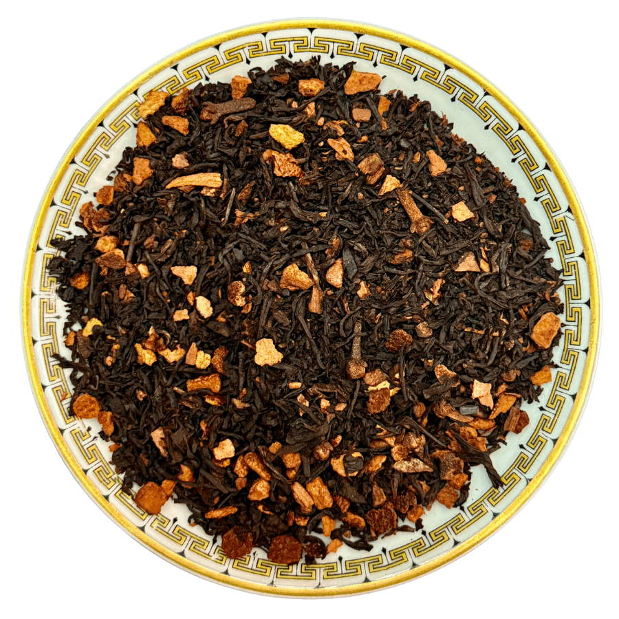 Cinnamon Orange Spice tea blend featuring black tea, organic cinnamon bark, and spices on a decorative plate.