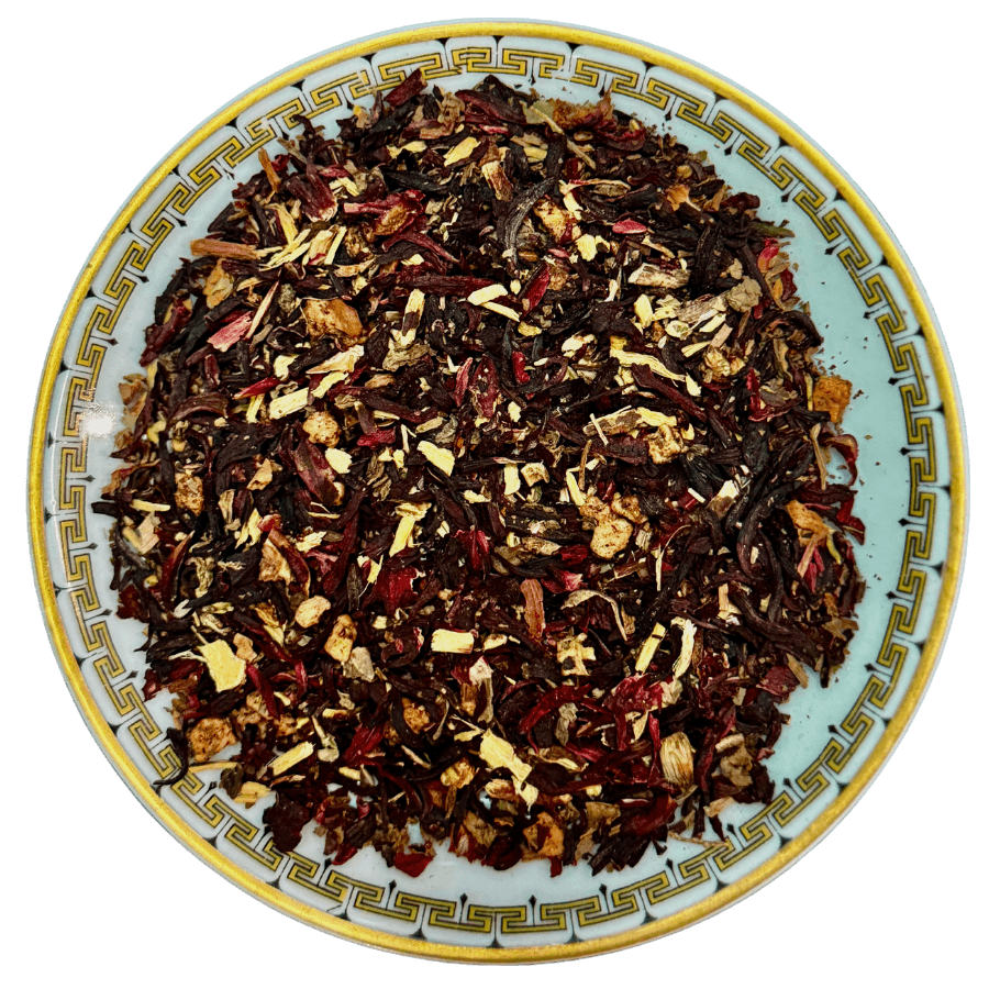 Tea leaves on a decorative ceramic plate with a white background