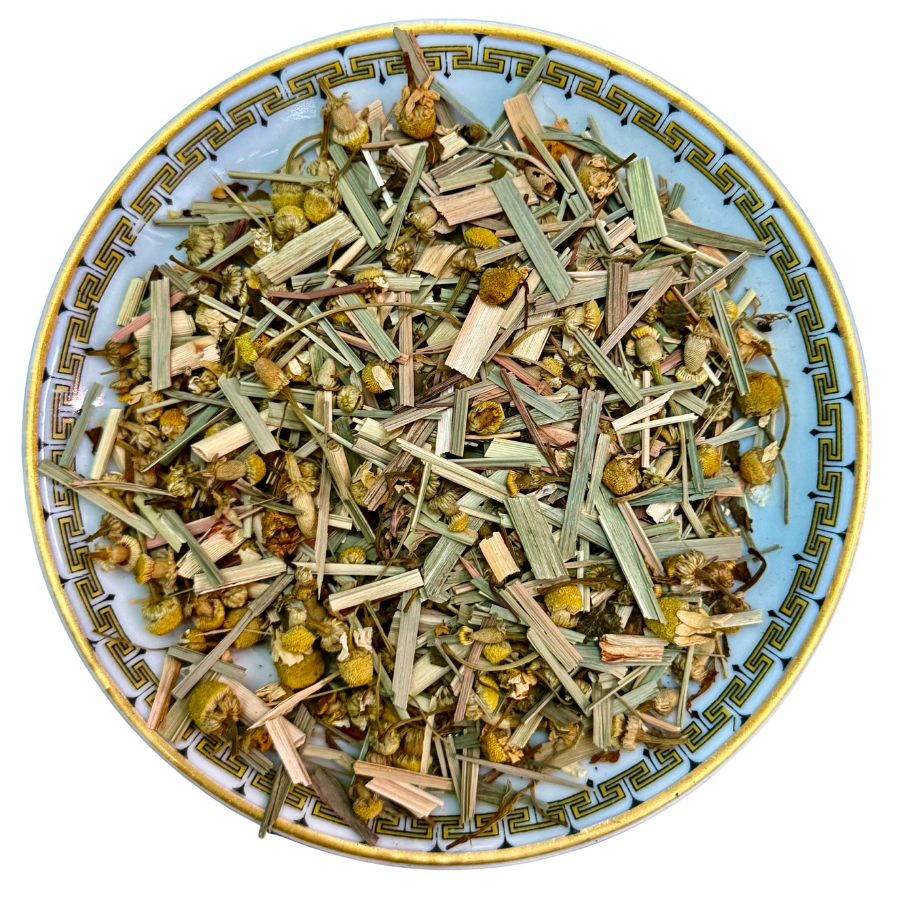 Herbal tea mix on a decorative plate with a white background