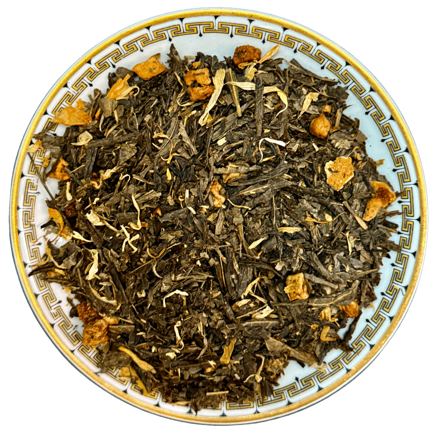 Tea leaves with orange pieces on a decorative plate