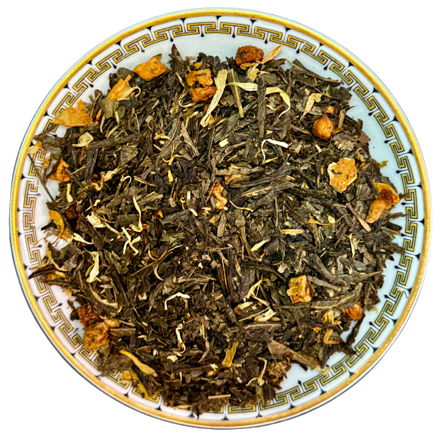 Tea leaves with orange pieces on a decorative plate