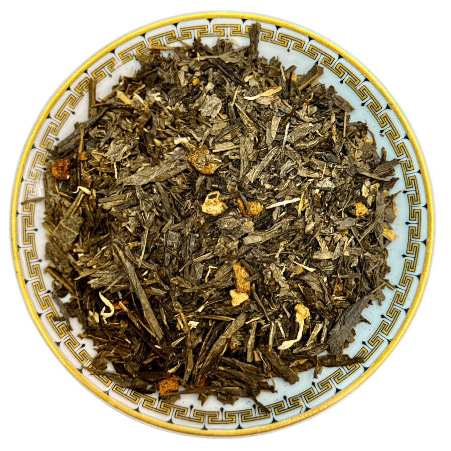 Tea leaves in a decorative bowl on a white background