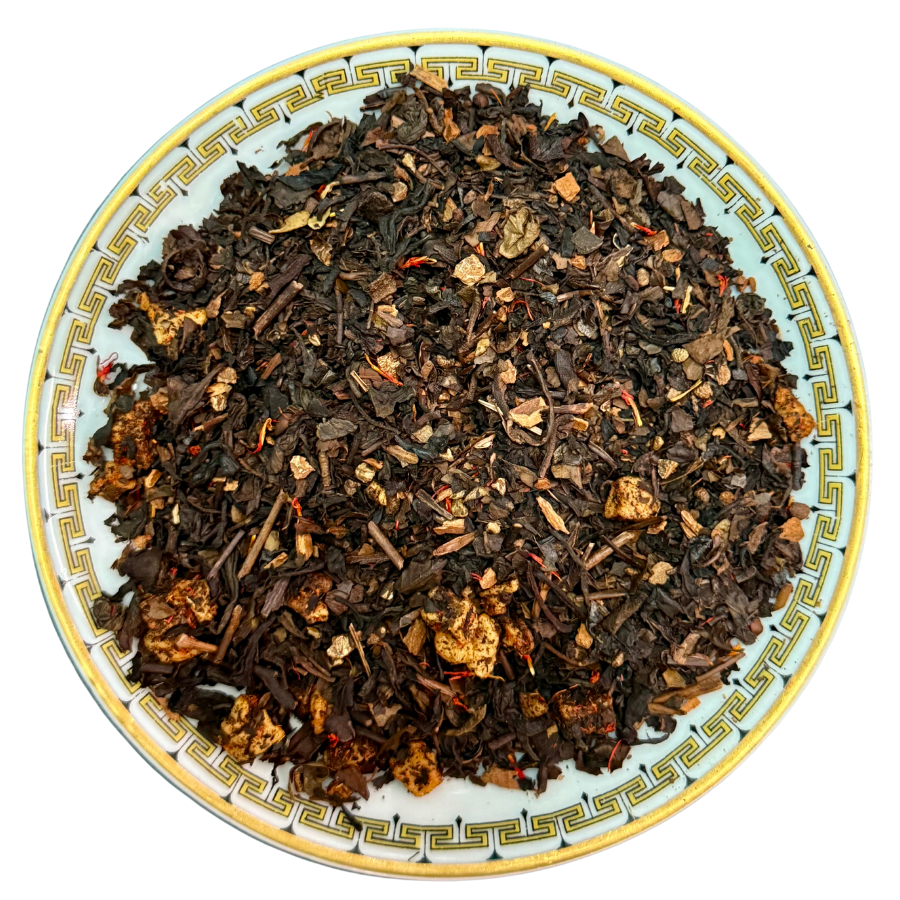 Tea leaves on a decorative plate with a white background