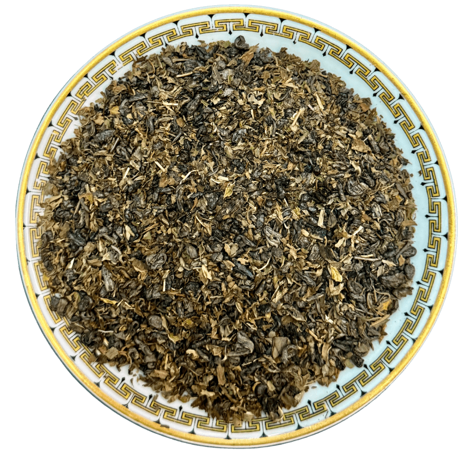 Tea leaves on a decorative ceramic plate with a white background