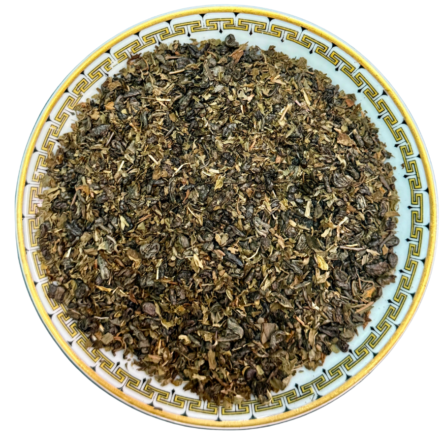 Tea leaves on a decorative ceramic plate with a white background