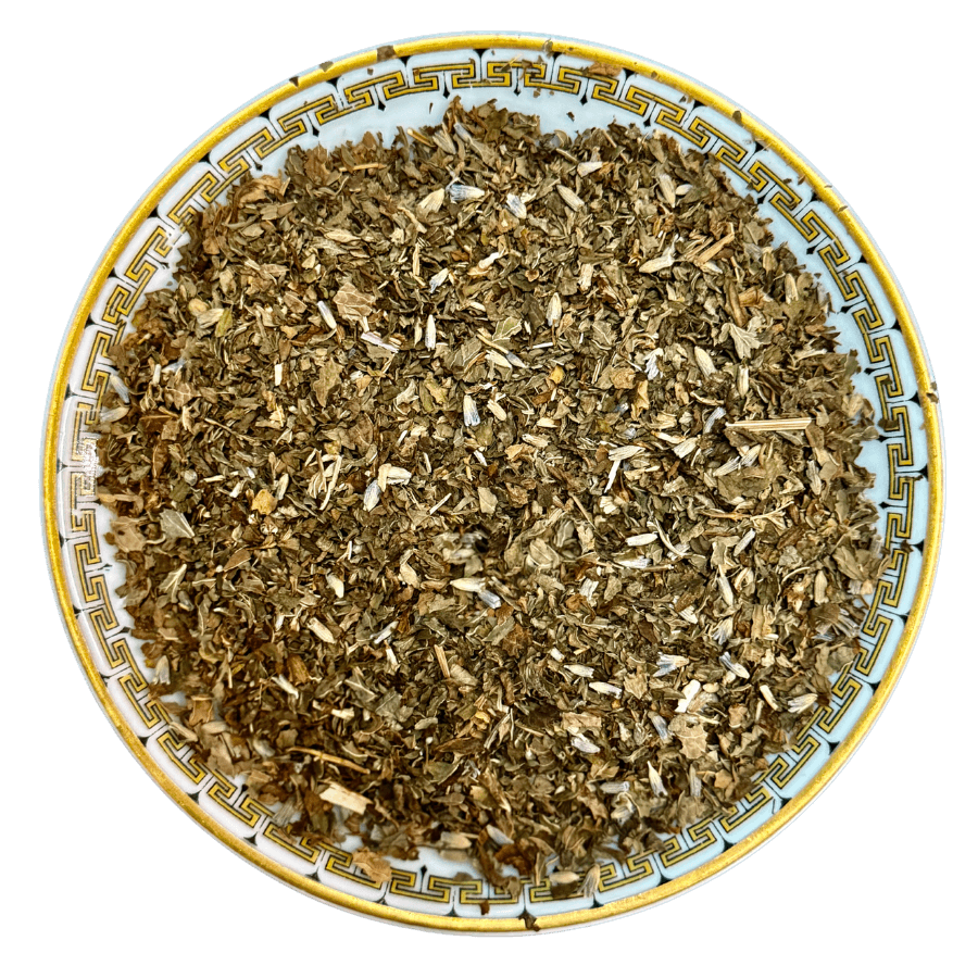 Dry herbs on a decorative plate with a white background