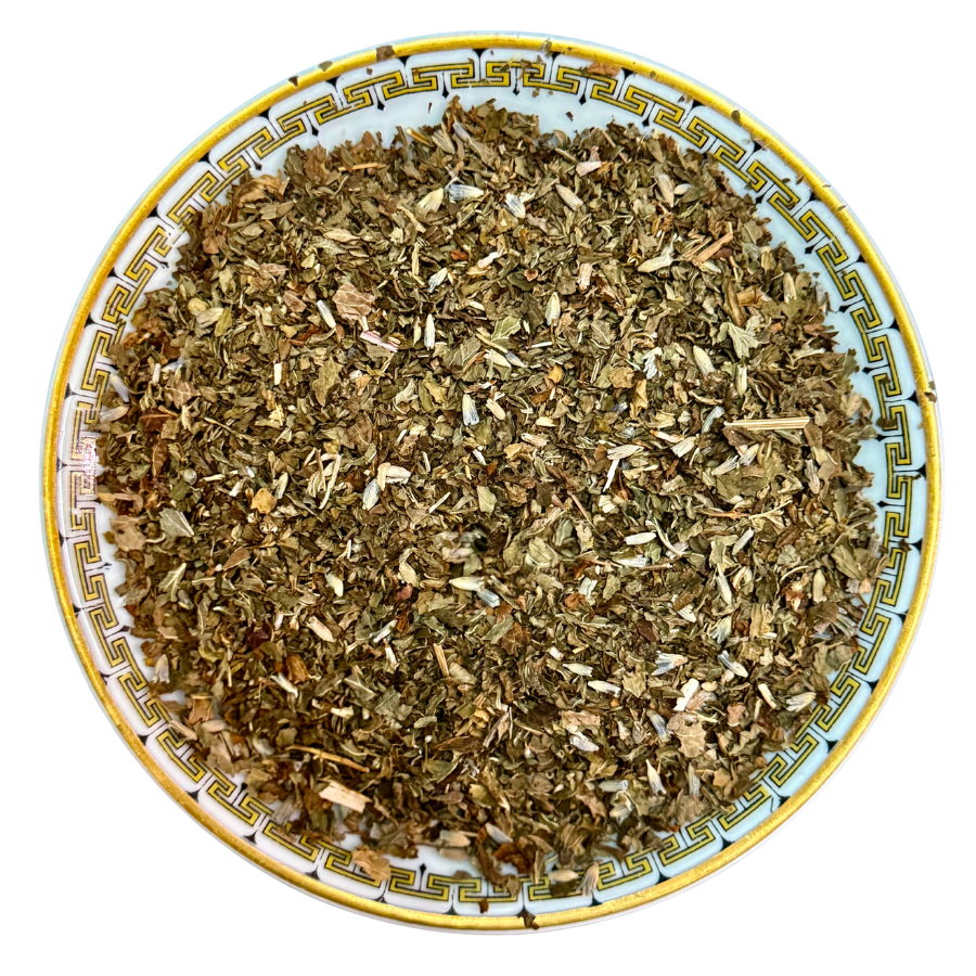 Dry herbs on a decorative plate with a white background