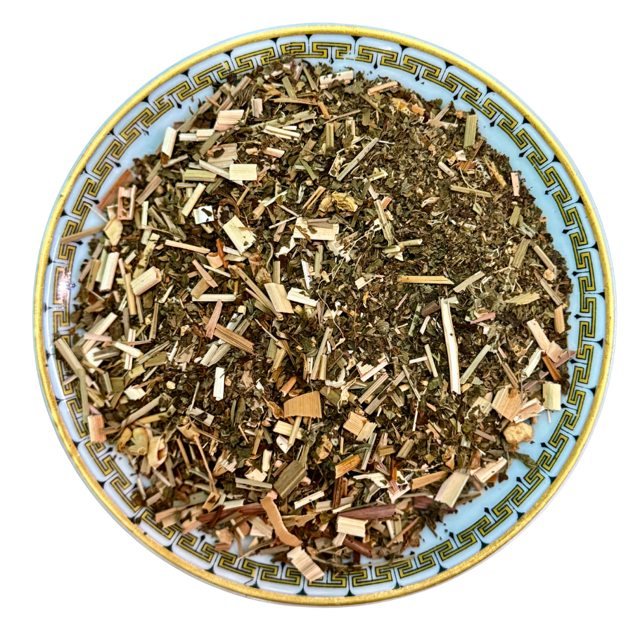 Herbal tea mix on a decorative plate with a white background