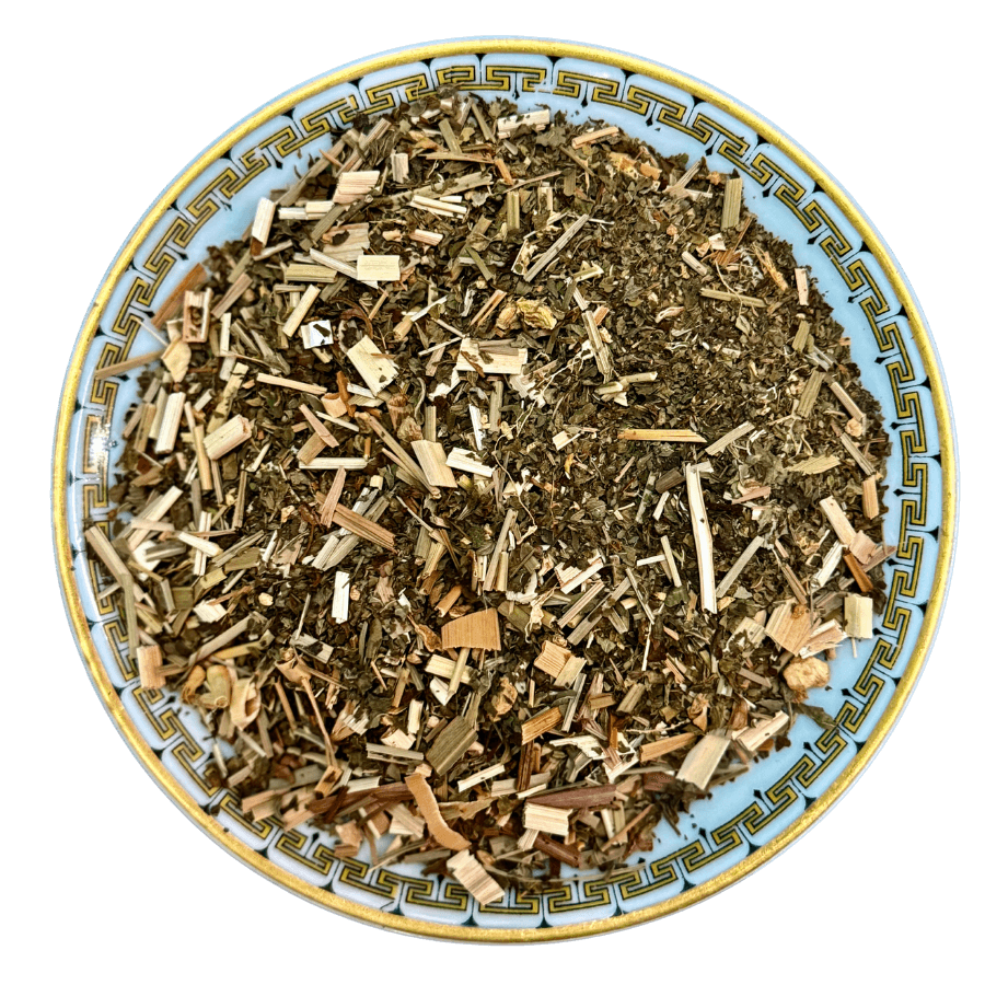 Herbal tea mix on a decorative plate with a white background