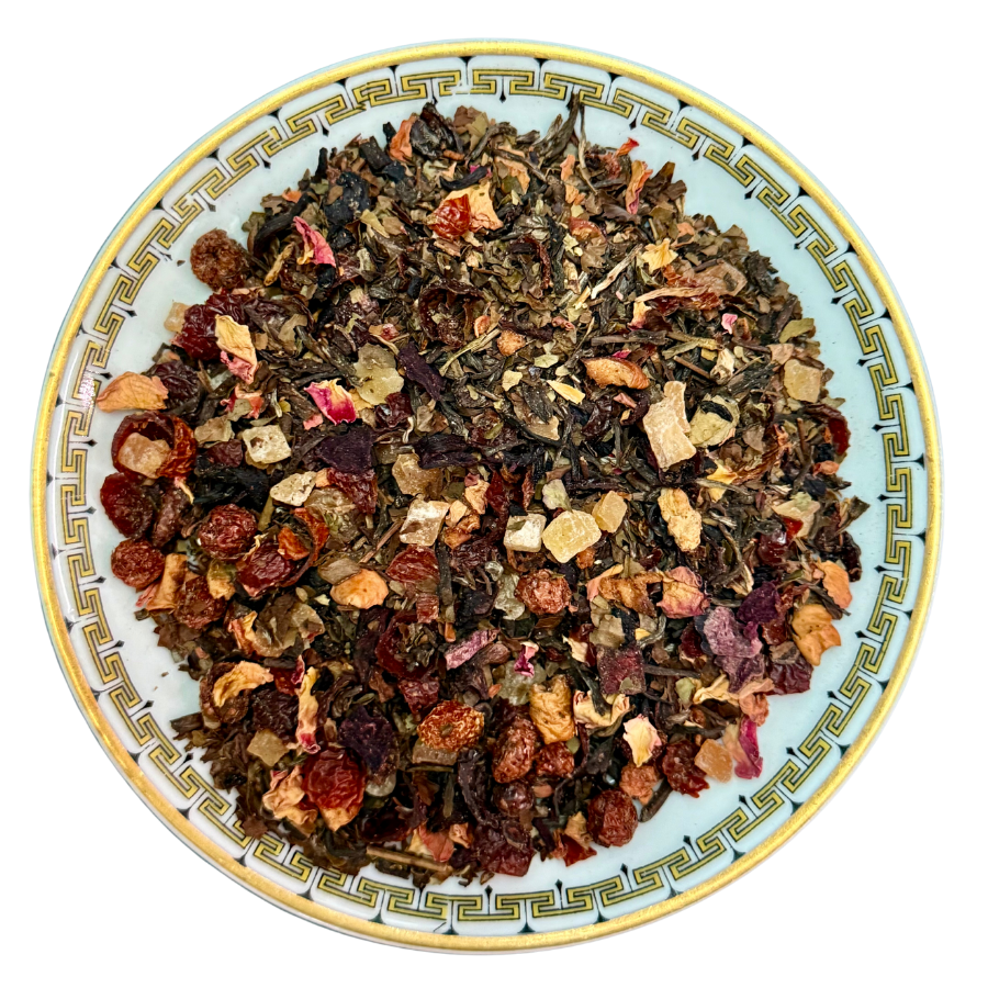 Assorted dried tea leaves on a decorative plate with a white background
