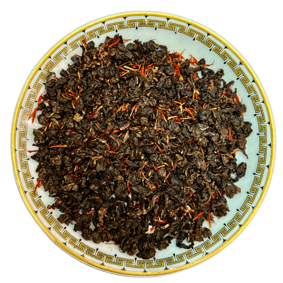 Tea leaves on a decorative ceramic plate with a white background