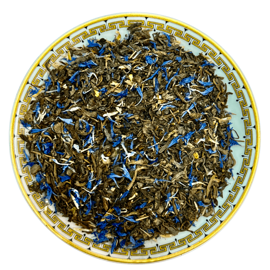 Tea leaves with blue flowers on a decorative ceramic plate