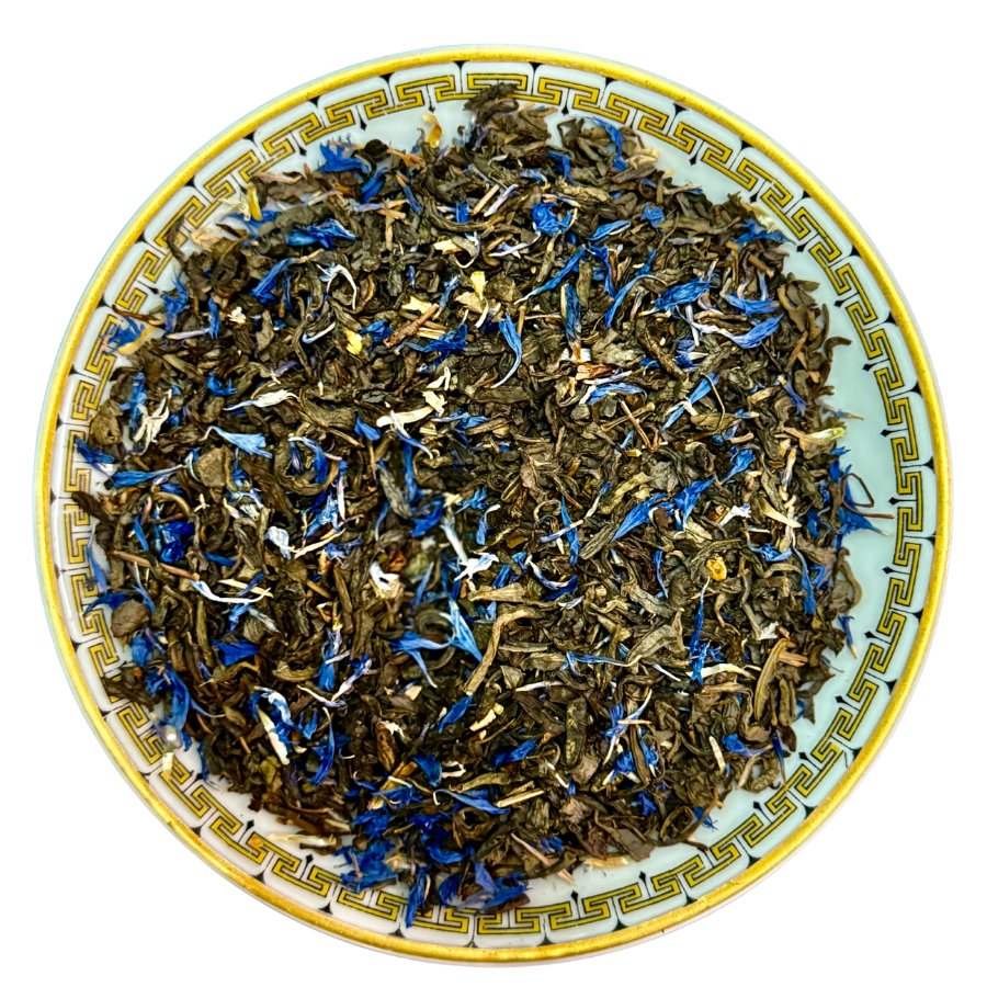 Tea leaves with blue flowers on a decorative ceramic plate