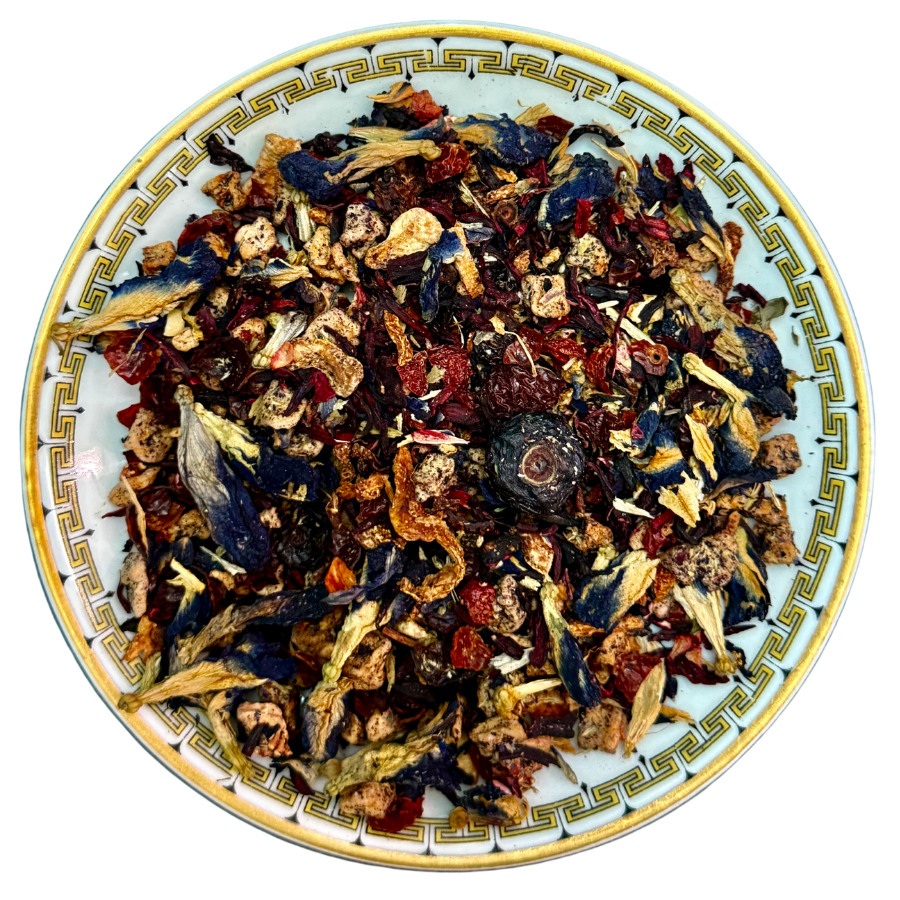 Assorted dried herbs and flowers on a decorative ceramic plate
