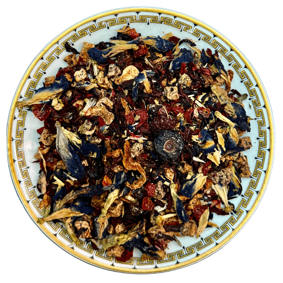 Assorted dried herbs and flowers on a decorative ceramic plate