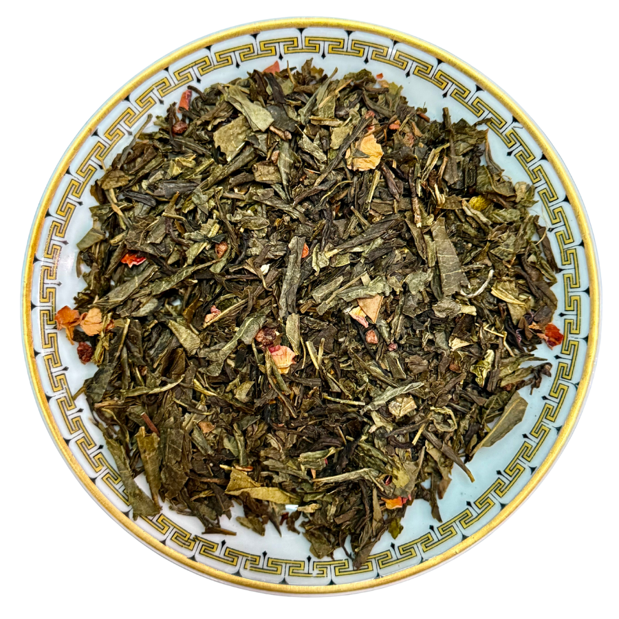 Tea leaves on a decorative ceramic plate with a white background