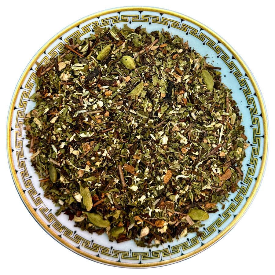 Dry herbs on a decorative plate with a white background