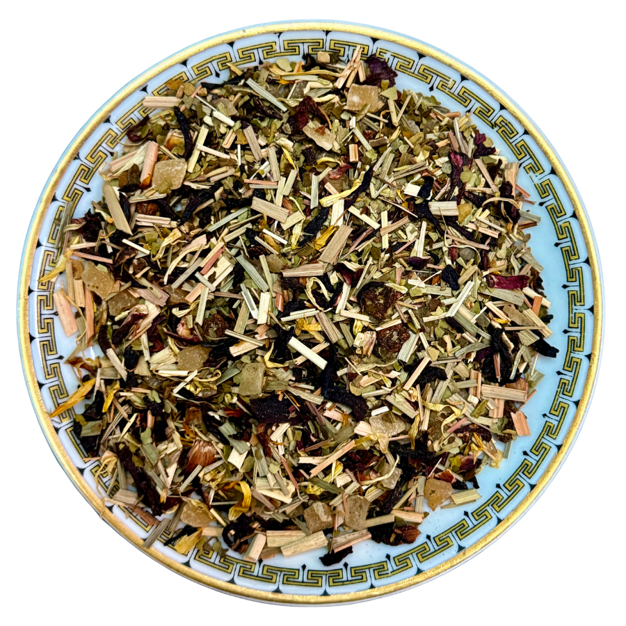 Herbal tea mix on a decorative plate with a white background
