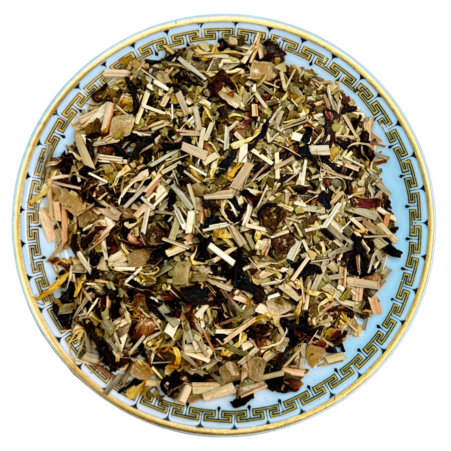 Herbal tea mix on a decorative plate with a white background