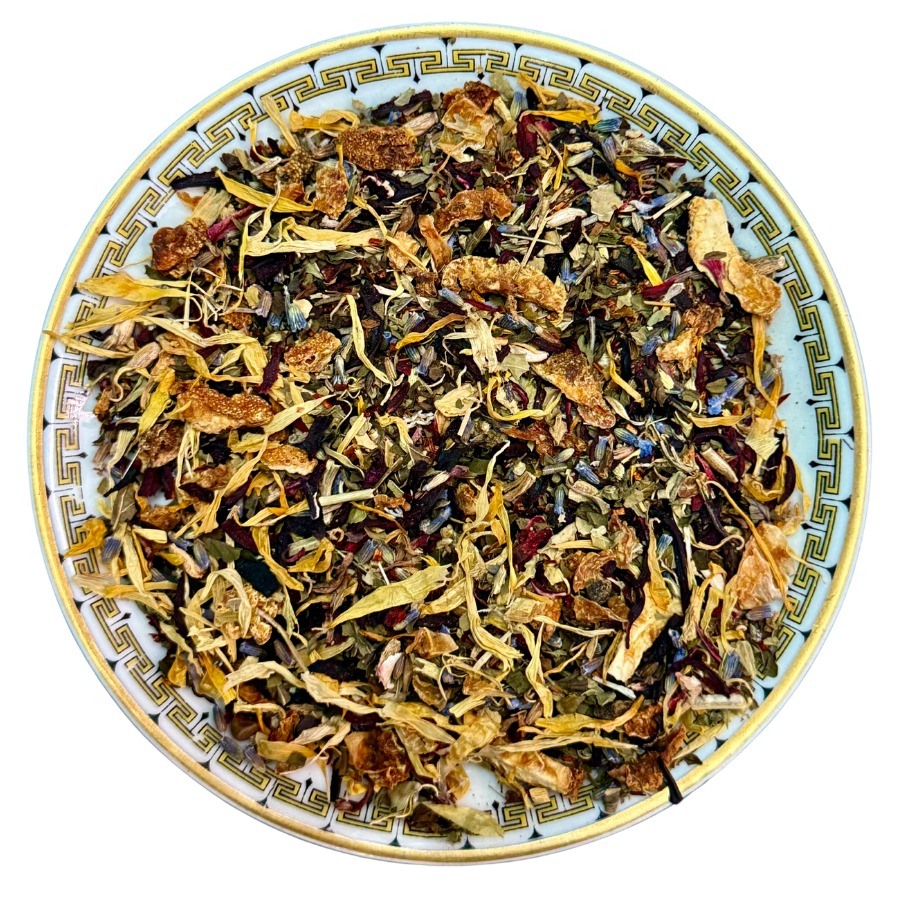 Assorted dried herbs and flowers on a decorative plate with a white background