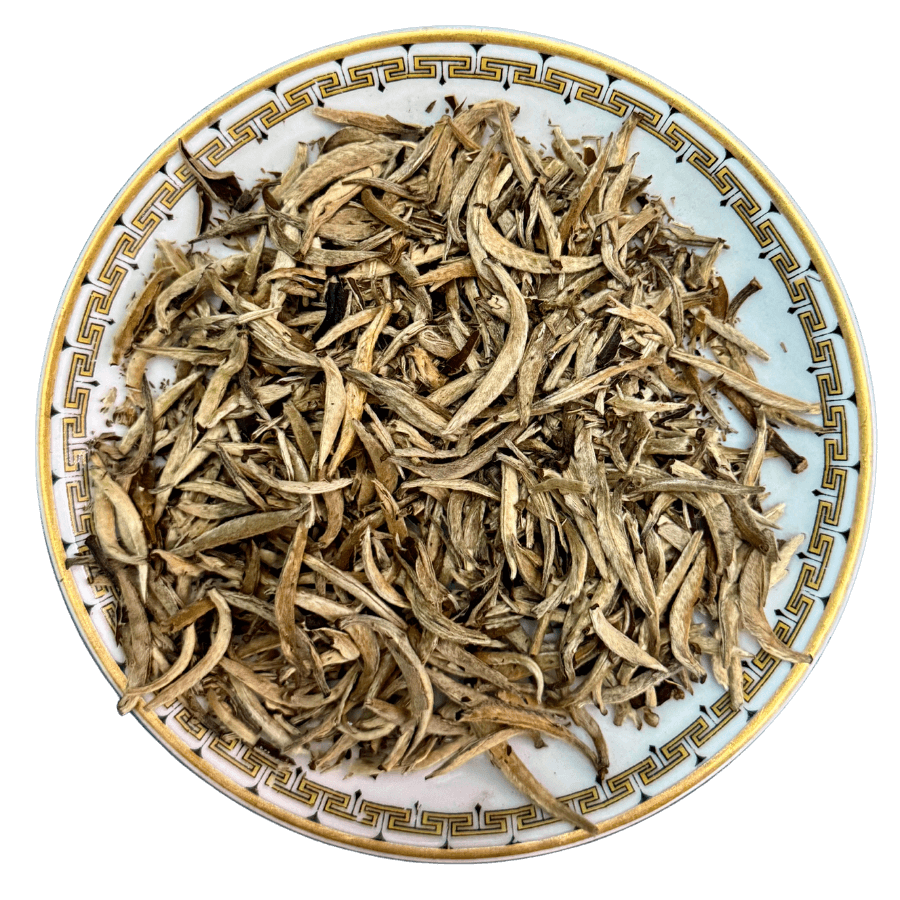 Dried tea leaves on a decorative ceramic plate