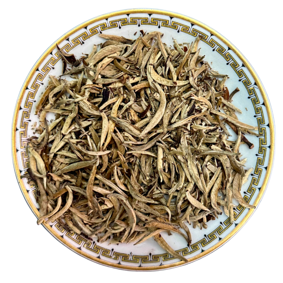 Dried tea leaves on a decorative ceramic plate