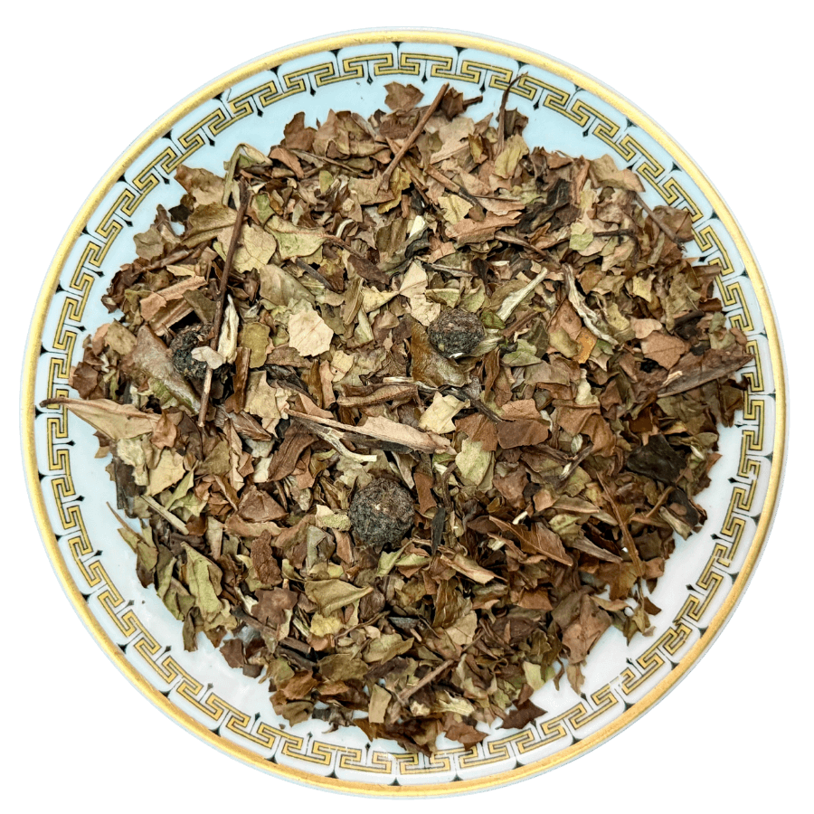 Dry herbs and leaves on a decorative ceramic plate