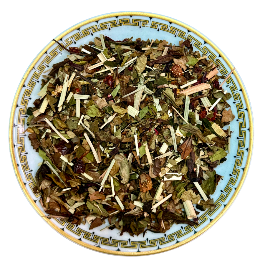 Herbal tea mix on a decorative plate with a white background