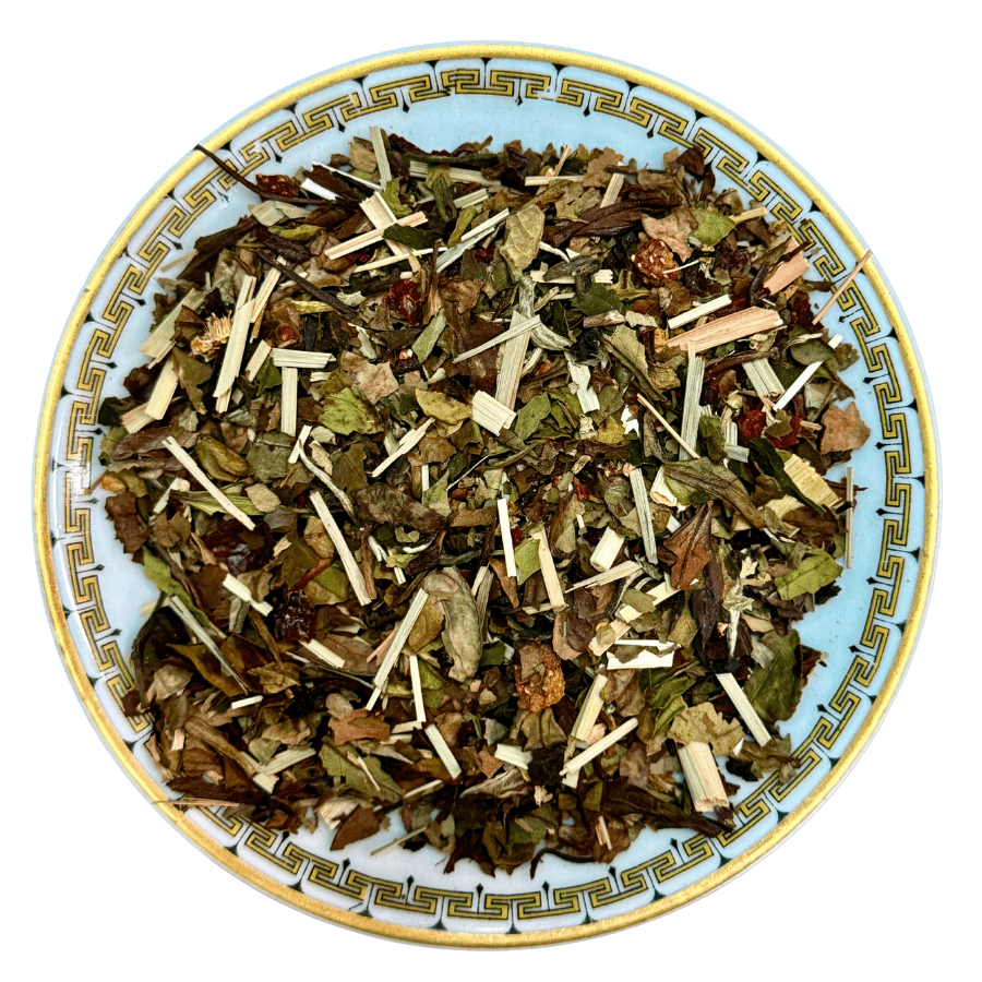 Herbal tea mix on a decorative plate with a white background