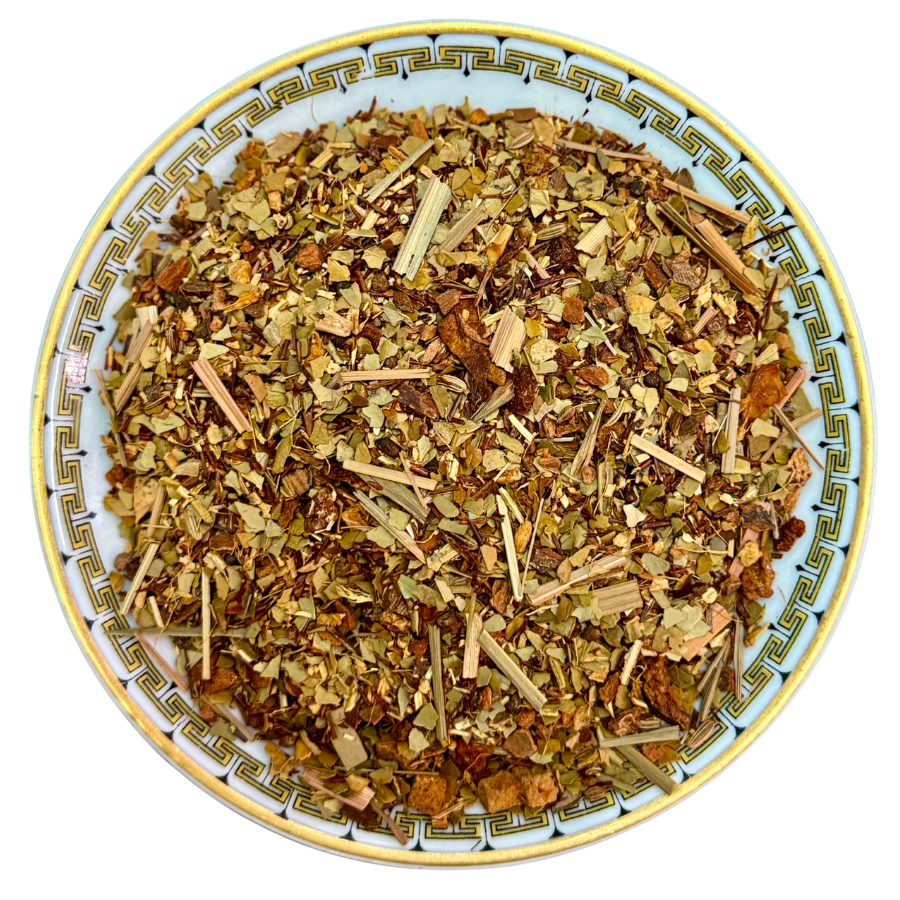 Herbal tea mix on a decorative plate with a white background