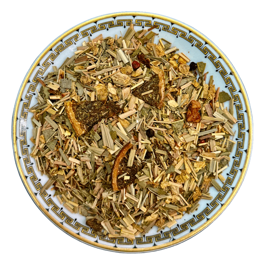 Assorted dried herbs and spices on a decorative plate with a white background
