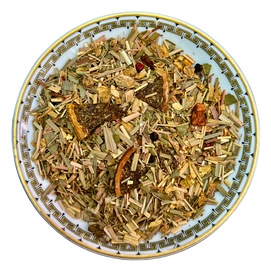 Assorted dried herbs and spices on a decorative plate with a white background
